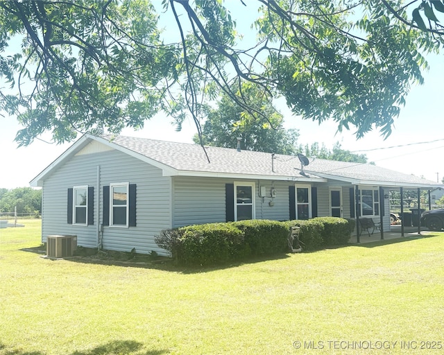 68 W Youth Cp, Healdton, OK 73438 - rear view of house with a lawn, central AC unit, and roof with shingles