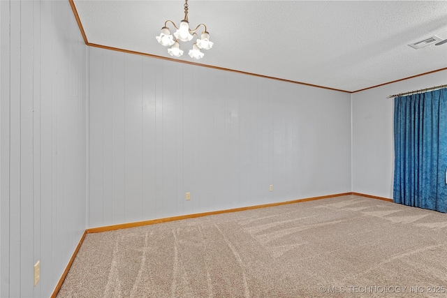 68 W Youth Cp, Healdton, OK 73438 - spare room with crown molding, carpet flooring, a chandelier, a textured ceiling, and baseboards