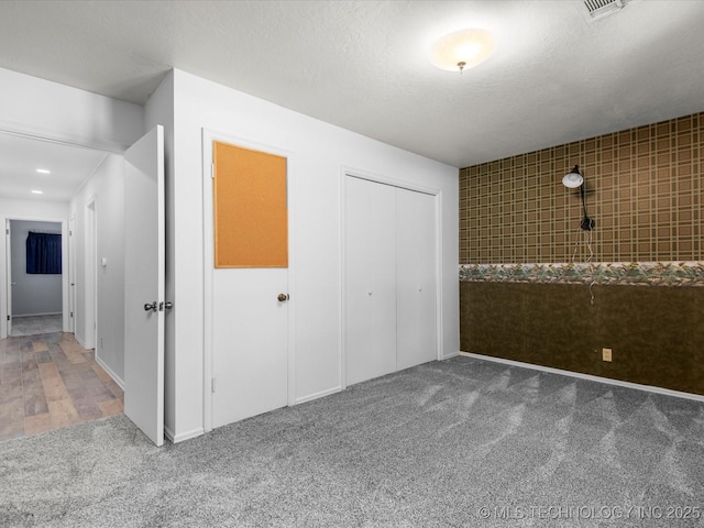 1044 Meadow Dr, Bartlesville, OK 74006 - unfurnished bedroom featuring carpet, a closet, and a textured ceiling