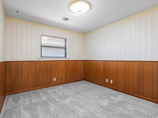 1044 Meadow Dr, Bartlesville, OK 74006 - empty room with a wainscoted wall and wood walls