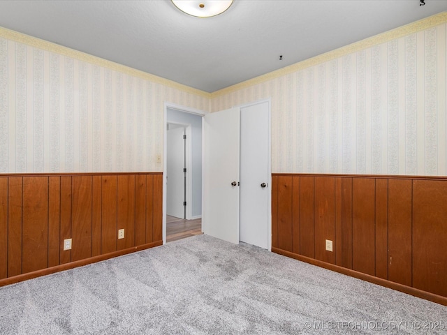1044 Meadow Dr, Bartlesville, OK 74006 - carpeted spare room with a wainscoted wall and wooden walls