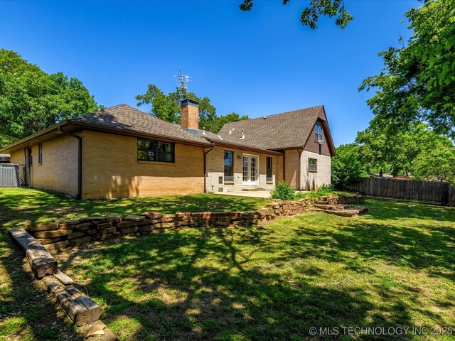 1044 Meadow Dr, Bartlesville, OK 74006 - back of property featuring brick siding, a patio, french doors, a chimney, and roof with shingles