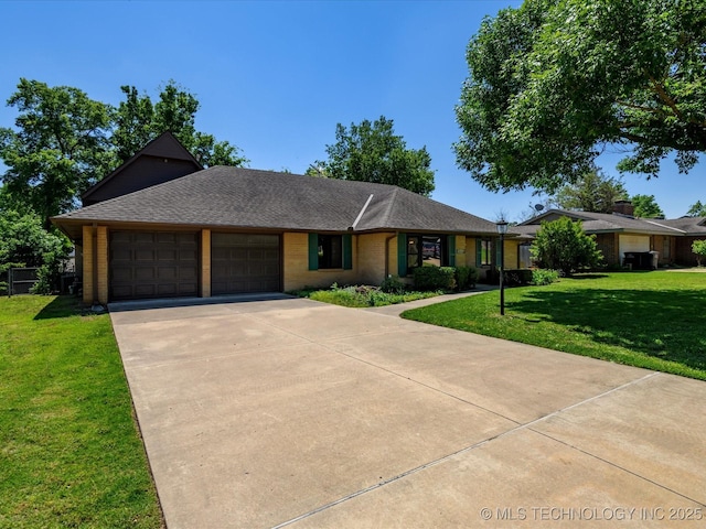 1044 Meadow Dr, Bartlesville, OK 74006 - ranch-style home featuring an attached garage, a front yard, concrete driveway, and a shingled roof