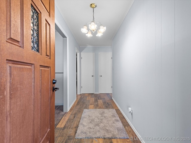 1044 Meadow Dr, Bartlesville, OK 74006 - corridor featuring dark wood finished floors, a chandelier, ornamental molding, and baseboards