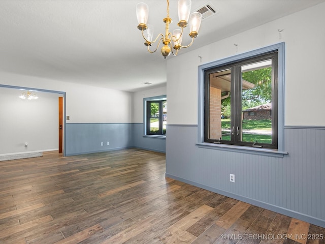 1044 Meadow Dr, Bartlesville, OK 74006 - spare room with a chandelier, wainscoting, and hardwood / wood-style floors