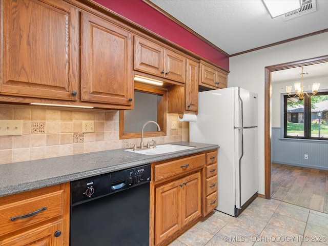 1044 Meadow Dr, Bartlesville, OK 74006 - kitchen with dishwasher, a sink, freestanding refrigerator, backsplash, and brown cabinets