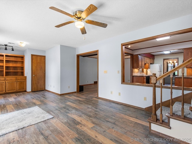 1044 Meadow Dr, Bartlesville, OK 74006 - unfurnished living room with ceiling fan, wood-type flooring, stairs, baseboards, and a textured ceiling