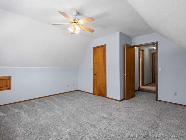 1044 Meadow Dr, Bartlesville, OK 74006 - bonus room with vaulted ceiling, carpet floors, baseboards, and a ceiling fan