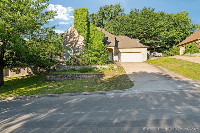 7646 S Fulton Ave, Tulsa, OK 74136 - view of front of home with concrete driveway, a front lawn, and an attached garage
