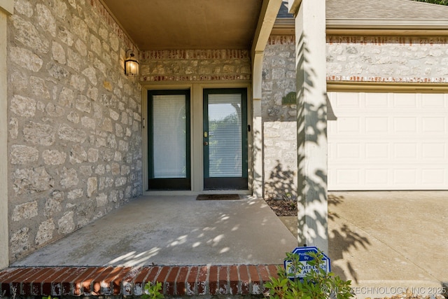 7646 S Fulton Ave, Tulsa, OK 74136 - doorway to property featuring stone siding and a shingled roof