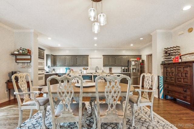 7646 S Fulton Ave, Tulsa, OK 74136 - dining space featuring crown molding, wood finished floors, baseboards, and recessed lighting