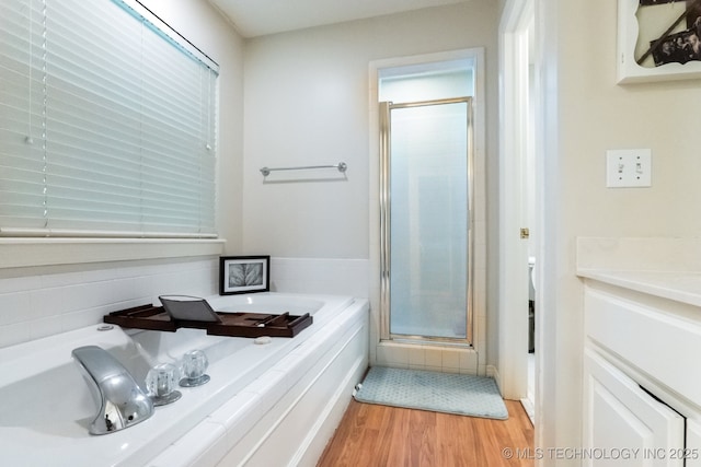 7646 S Fulton Ave, Tulsa, OK 74136 - bathroom featuring a stall shower, wood finished floors, and a bath
