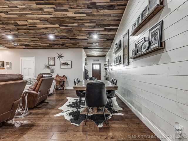 29550 S 4240th Rd, Inola, OK 74036 - dining space featuring wood walls, dark wood-type flooring, and baseboards