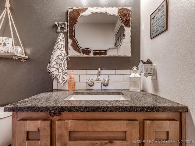 29550 S 4240th Rd, Inola, OK 74036 - half bath featuring a textured wall, vanity, tasteful backsplash, and toilet