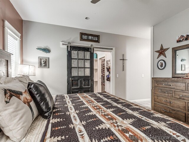 29550 S 4240th Rd, Inola, OK 74036 - bedroom featuring a spacious closet and a barn door