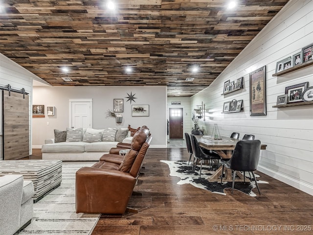 29550 S 4240th Rd, Inola, OK 74036 - living area featuring a barn door, wood walls, wood finished floors, baseboards, and vaulted ceiling