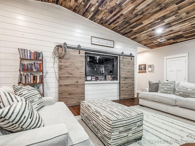 29550 S 4240th Rd, Inola, OK 74036 - living room with a barn door, wood walls, lofted ceiling, wood finished floors, and wood ceiling
