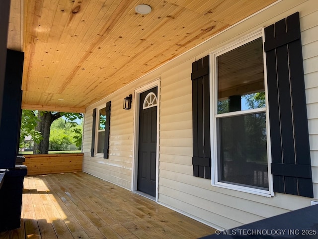 618 E Gentry Ave, Checotah, OK 74426 - wooden terrace with covered porch