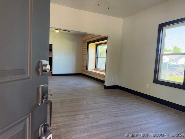 618 E Gentry Ave, Checotah, OK 74426 - empty room with wood finished floors, baseboards, and a ceiling fan