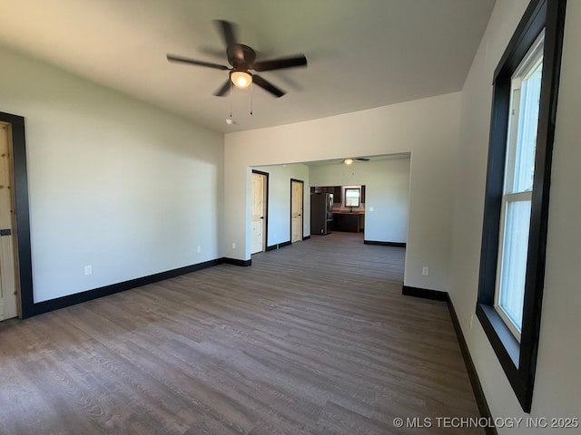 618 E Gentry Ave, Checotah, OK 74426 - empty room featuring ceiling fan, dark wood-style floors, and baseboards
