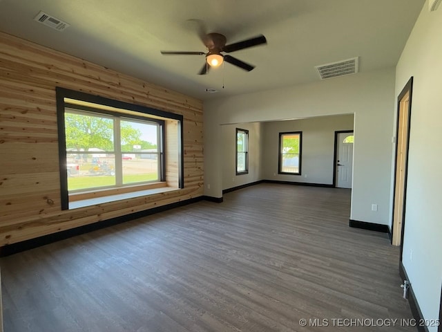 618 E Gentry Ave, Checotah, OK 74426 - unfurnished room with a ceiling fan, wood finished floors, baseboards, and wood walls