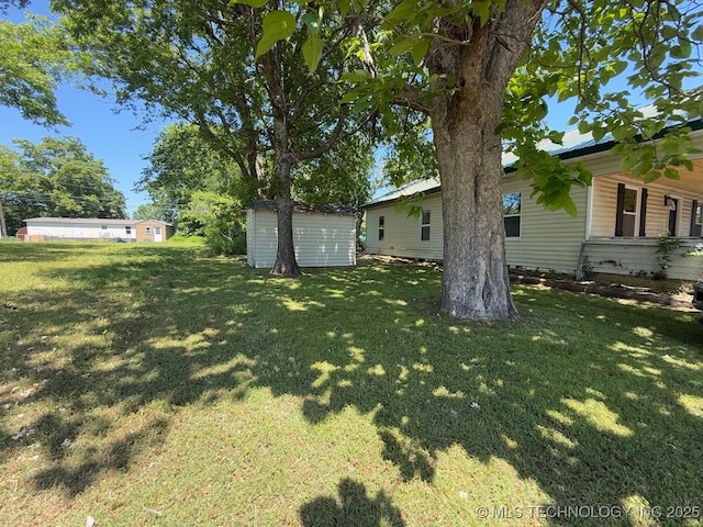 618 E Gentry Ave, Checotah, OK 74426 - view of green lawn with a storage shed and an outdoor structure