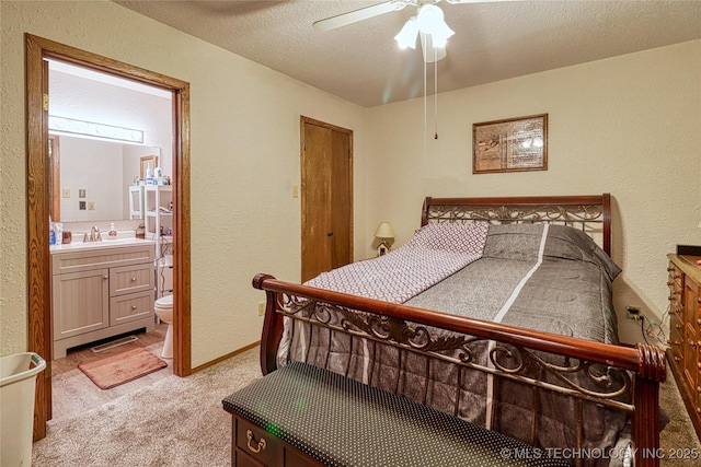 5831 Evans, Kingston, OK 73439 - bedroom with a textured wall, light carpet, a sink, a textured ceiling, and connected bathroom