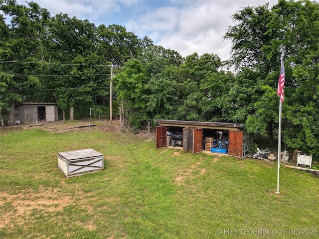 5831 Evans, Kingston, OK 73439 - view of grassy yard featuring an outbuilding and a storage unit