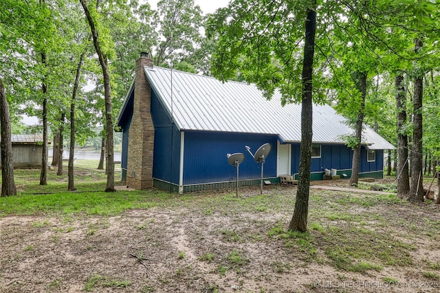 5831 Evans, Kingston, OK 73439 - view of front of property featuring a chimney and metal roof