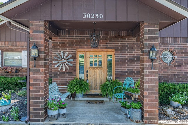 30230 S 562, Afton, OK 74331 - doorway to property featuring brick siding and board and batten siding