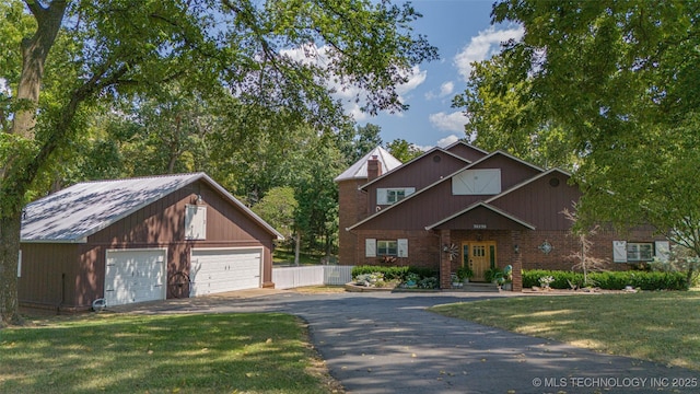 30230 S 562, Afton, OK 74331 - view of front of house with a garage, an outbuilding, cooling unit, and brick siding