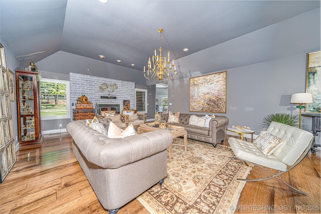 30230 S 562, Afton, OK 74331 - living area with vaulted ceiling, a chandelier, wood finished floors, a brick fireplace, and baseboards