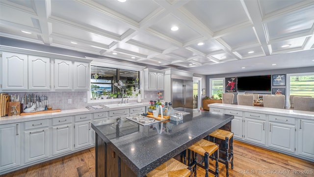 30230 S 562, Afton, OK 74331 - kitchen with light wood-style floors, a kitchen bar, stainless steel built in refrigerator, a kitchen island, and backsplash