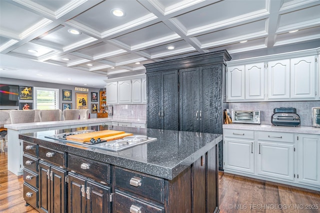 30230 S 562, Afton, OK 74331 - kitchen featuring cooktop, wood finished floors, white cabinets, backsplash, and coffered ceiling