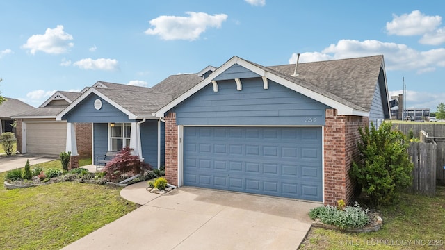 ranch-style home featuring brick siding, a garage, a shingled roof, and concrete driveway