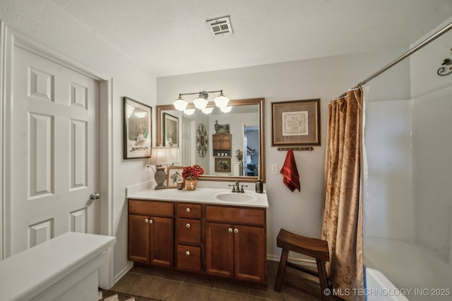 bathroom with vanity, tile patterned floors, shower / tub combo with curtain, and baseboards