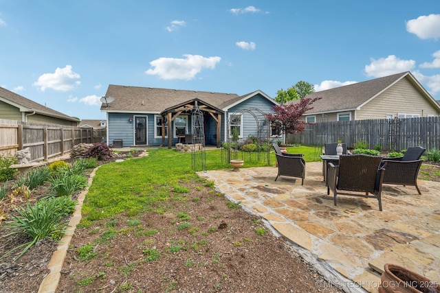 rear view of property featuring a patio area