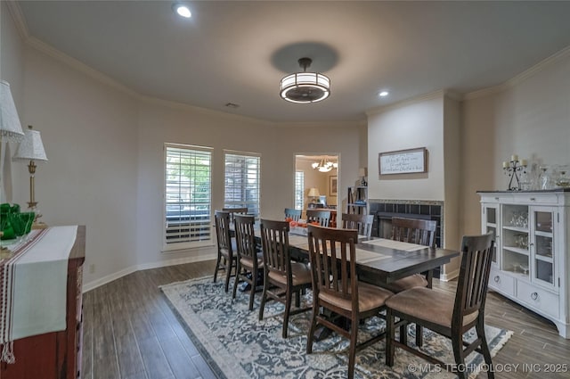 8212 S Delaware Pl, Tulsa, OK 74137 - dining room with wood finished floors, a chandelier, crown molding, a fireplace, and recessed lighting
