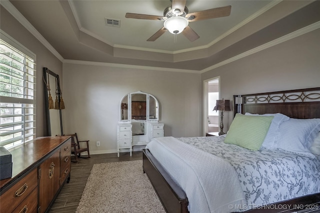 8212 S Delaware Pl, Tulsa, OK 74137 - bedroom featuring a tray ceiling, dark wood-type flooring, baseboards, ceiling fan, and crown molding