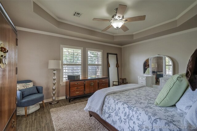 8212 S Delaware Pl, Tulsa, OK 74137 - bedroom featuring a tray ceiling, baseboards, dark wood finished floors, ornamental molding, and a ceiling fan
