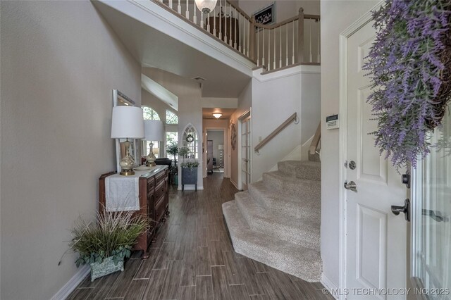 8212 S Delaware Pl, Tulsa, OK 74137 - foyer with a high ceiling, dark wood-style floors, stairway, and baseboards
