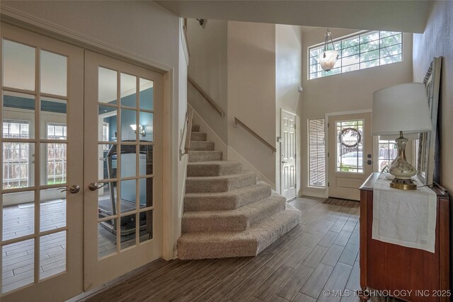 8212 S Delaware Pl, Tulsa, OK 74137 - entryway with stairway, dark wood-style floors, french doors, a towering ceiling, and baseboards