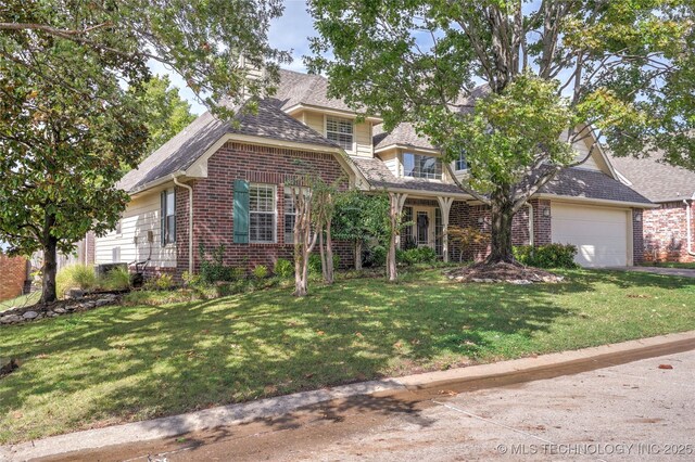8212 S Delaware Pl, Tulsa, OK 74137 - view of front of home with brick siding, a front yard, and an attached garage