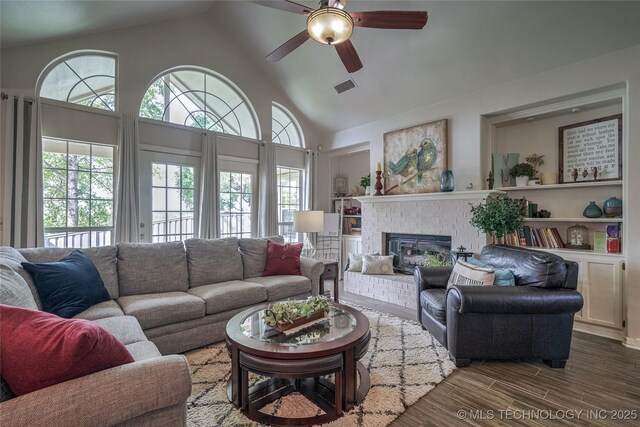 8212 S Delaware Pl, Tulsa, OK 74137 - living area with a ceiling fan, plenty of natural light, a brick fireplace, wood finished floors, and high vaulted ceiling