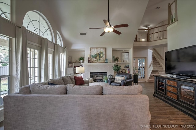 8212 S Delaware Pl, Tulsa, OK 74137 - living area featuring high vaulted ceiling, a glass covered fireplace, ceiling fan, dark wood finished floors, and stairway