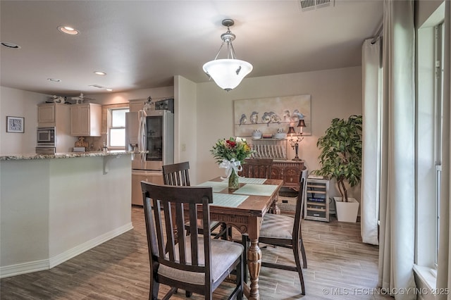 8212 S Delaware Pl, Tulsa, OK 74137 - dining room featuring wood finished floors, recessed lighting, wine cooler, and baseboards