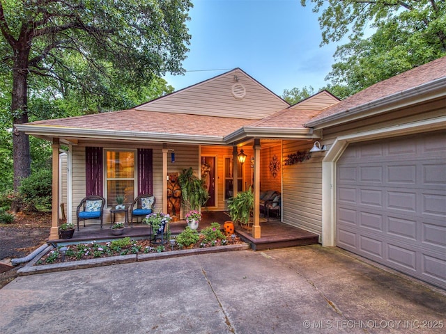 view of front of property with covered porch, concrete driveway, an attached garage, and a shingled roof