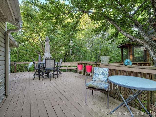 deck with outdoor dining area