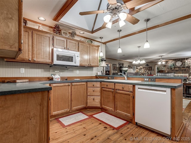kitchen with white appliances, ceiling fan, a peninsula, dark countertops, and crown molding