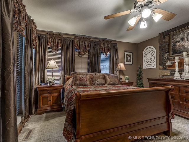 bedroom with light colored carpet and a ceiling fan